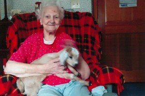Mary Tomaski holds a baby goat born just one week ago.